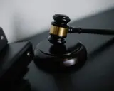 Młotek sędziowski i akta. Droga do tego, jak zostać sędzią, wymaga wiedzy i determinacji.